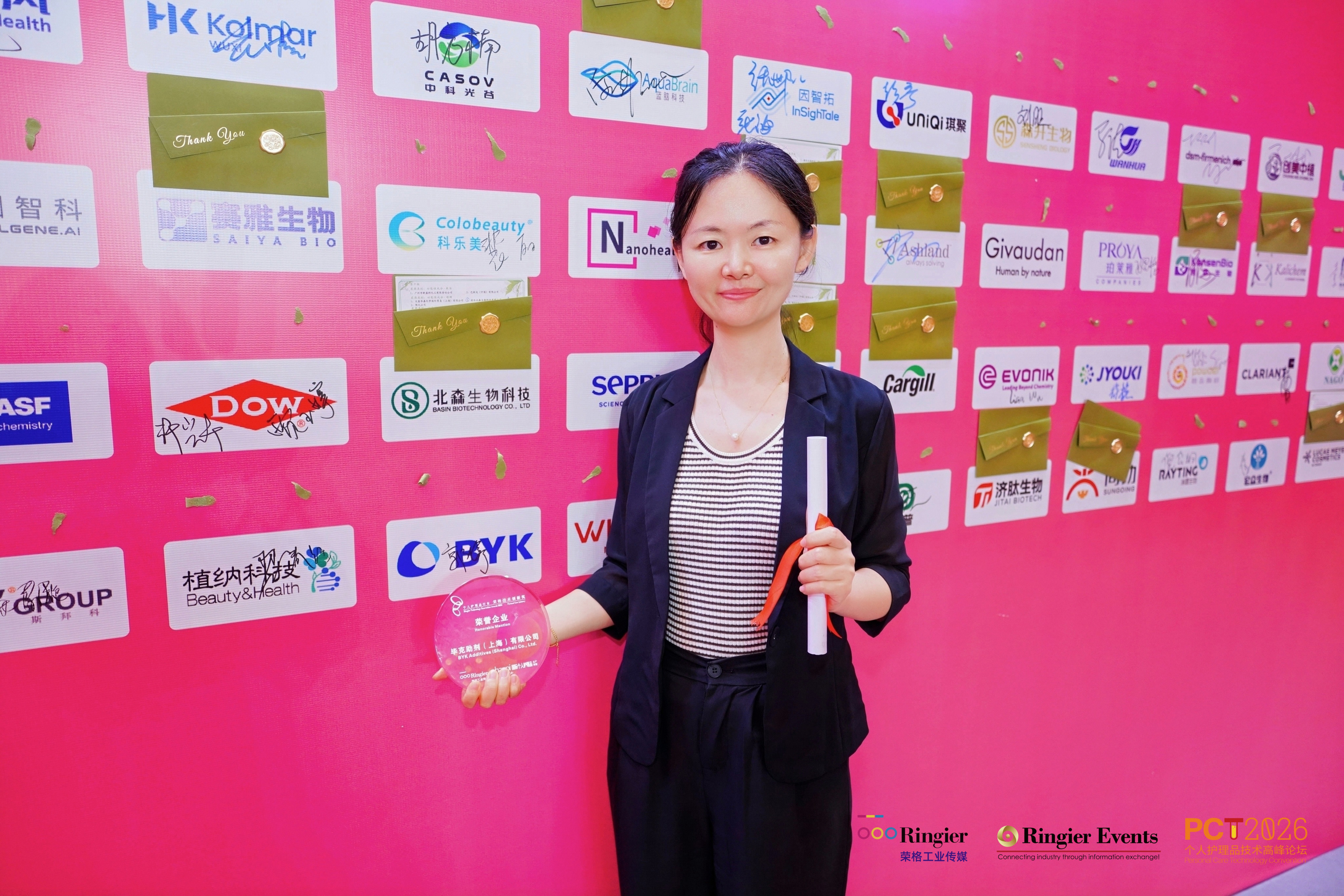 BYK representative in front of the photo wall at the Ringier Awards
