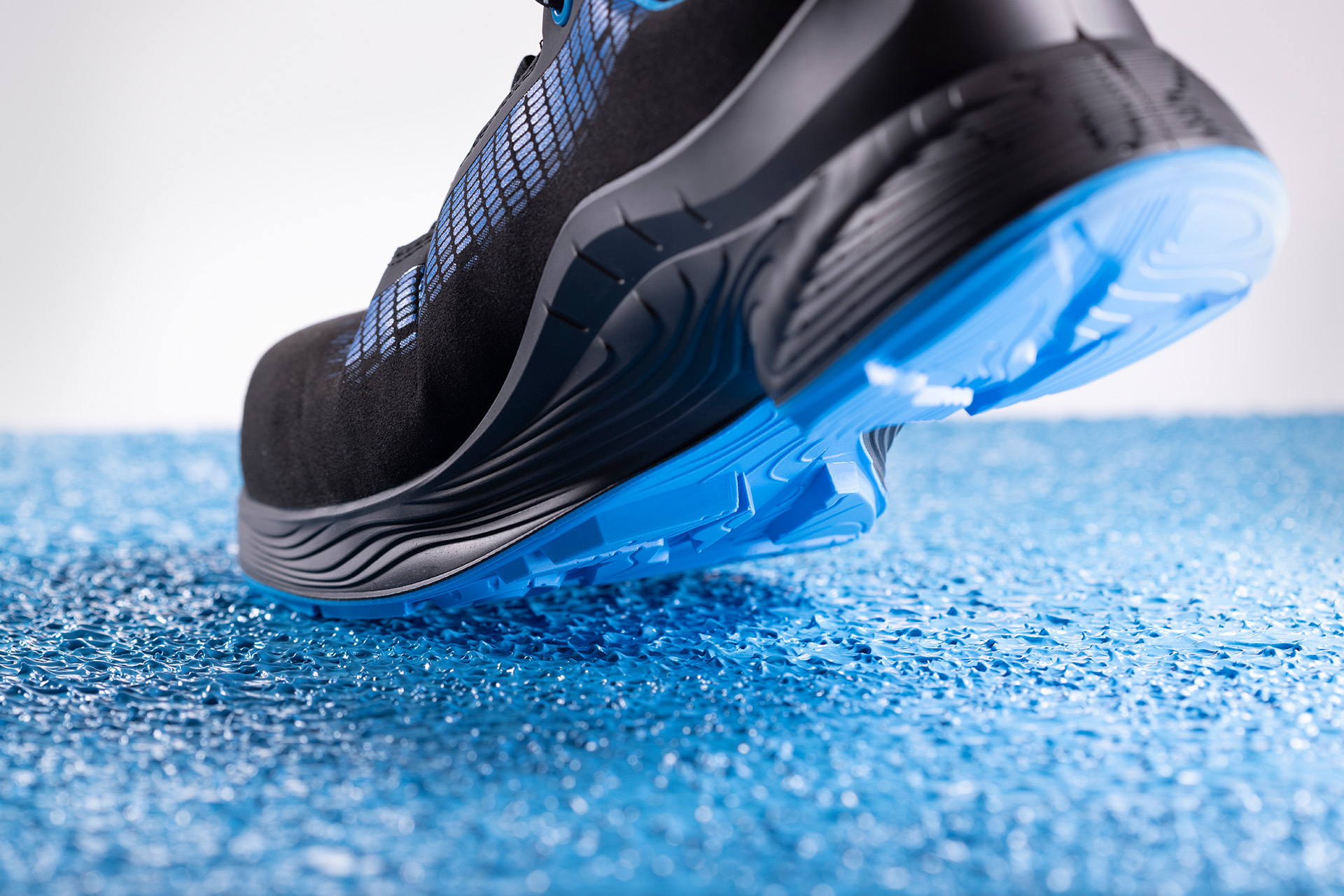 Shoe stepping on blue floor