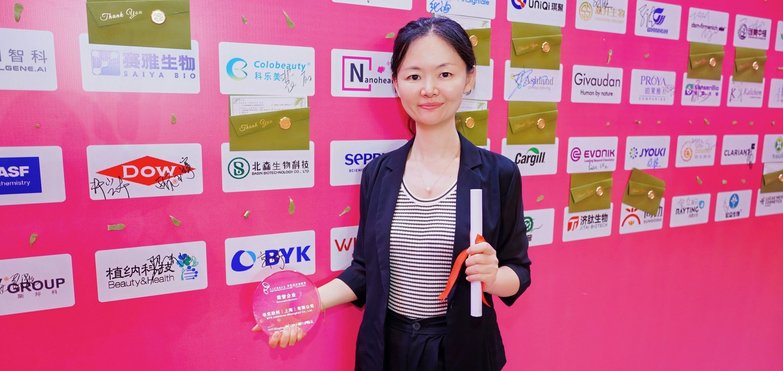BYK representative in front of the photo wall at the Ringier Awards